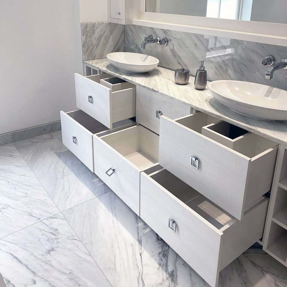 Open shelving and drawers around the mirrored area