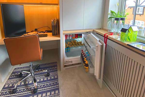 A concealed pull-out compartment inside a bespoke unit