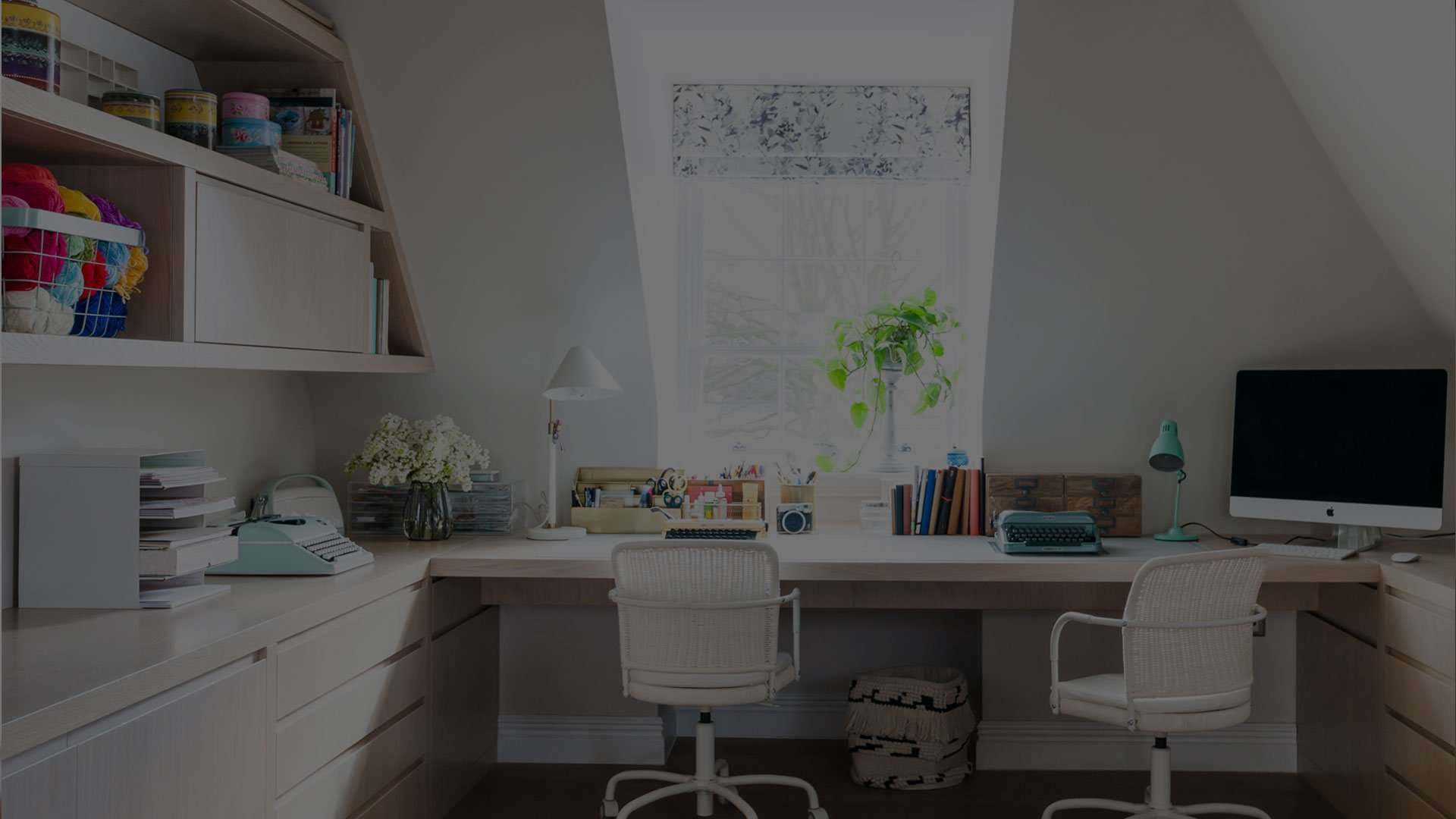 Fitted home office with a typewriter, books and plants