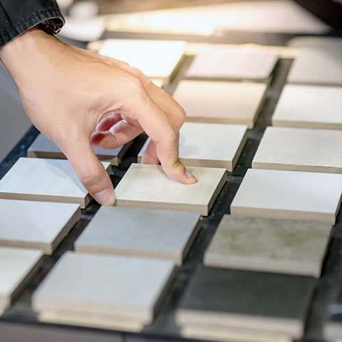 A hand choosing from physical material and finish samples