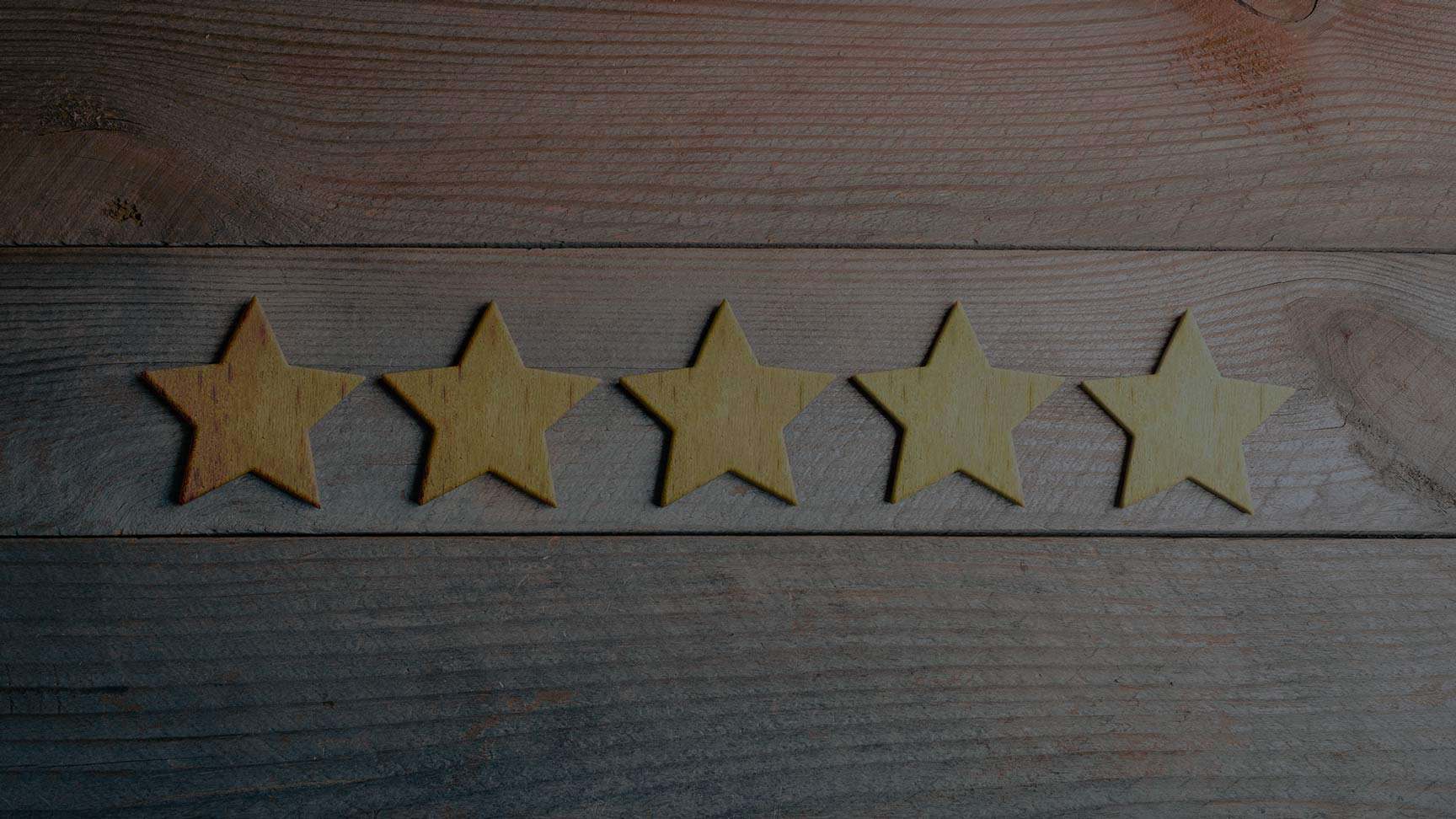 Wooden stars on a dark stained timber wall