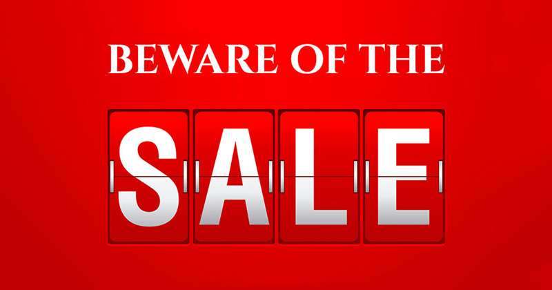 A red poster reading BEWARE OF THE SALE