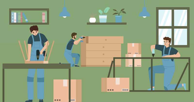 Two fitters assembling furniture in a room