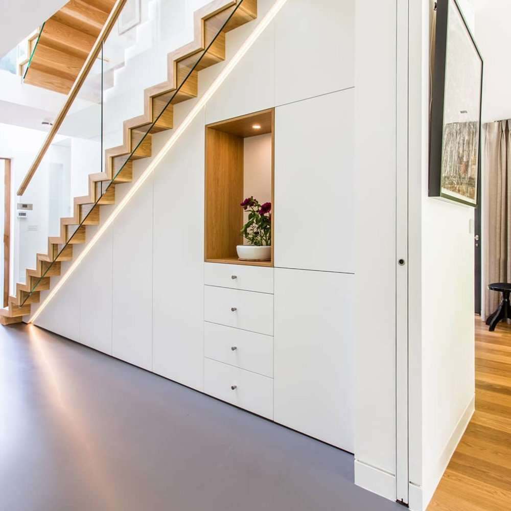 Understairs storage unit with its doors closed