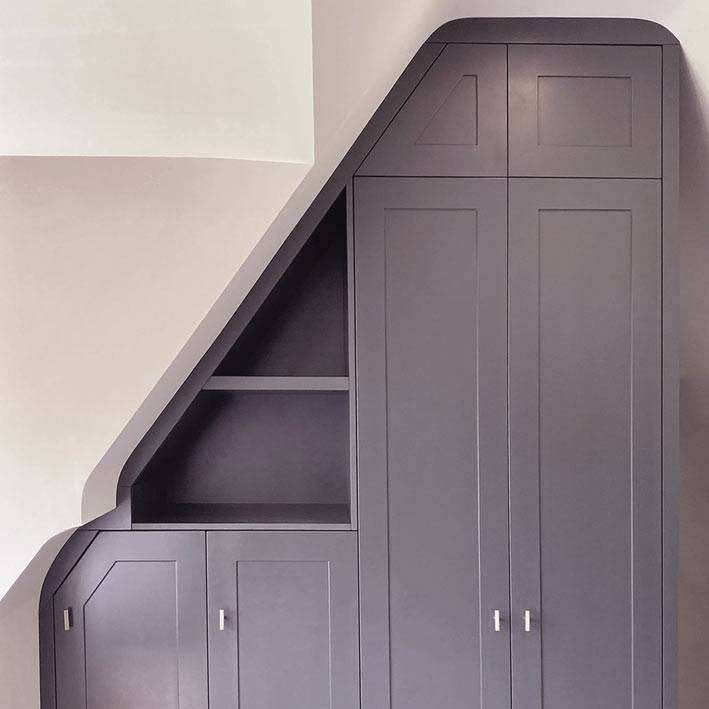 Bespoke wardrobe following the curve of the wall