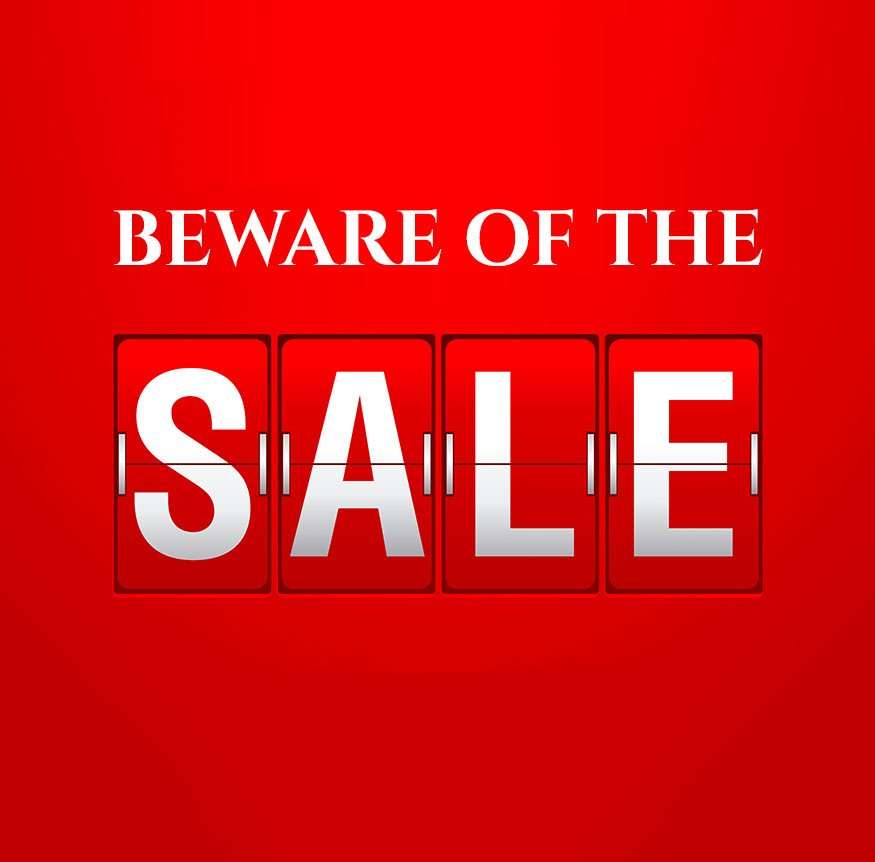 A red sale sign reading Beware of the sale